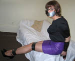 trannie in tight leather miniskirt, tape gag, and tape bondage