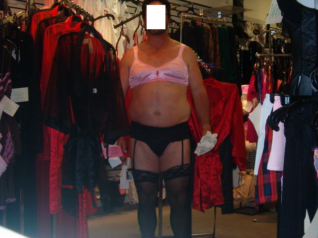 pretty 69 sissy wearing pink bra, black garter, black panties, and black stockings