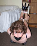 trannie Sandra lounges in corset and heels when she is subdued and hog tied